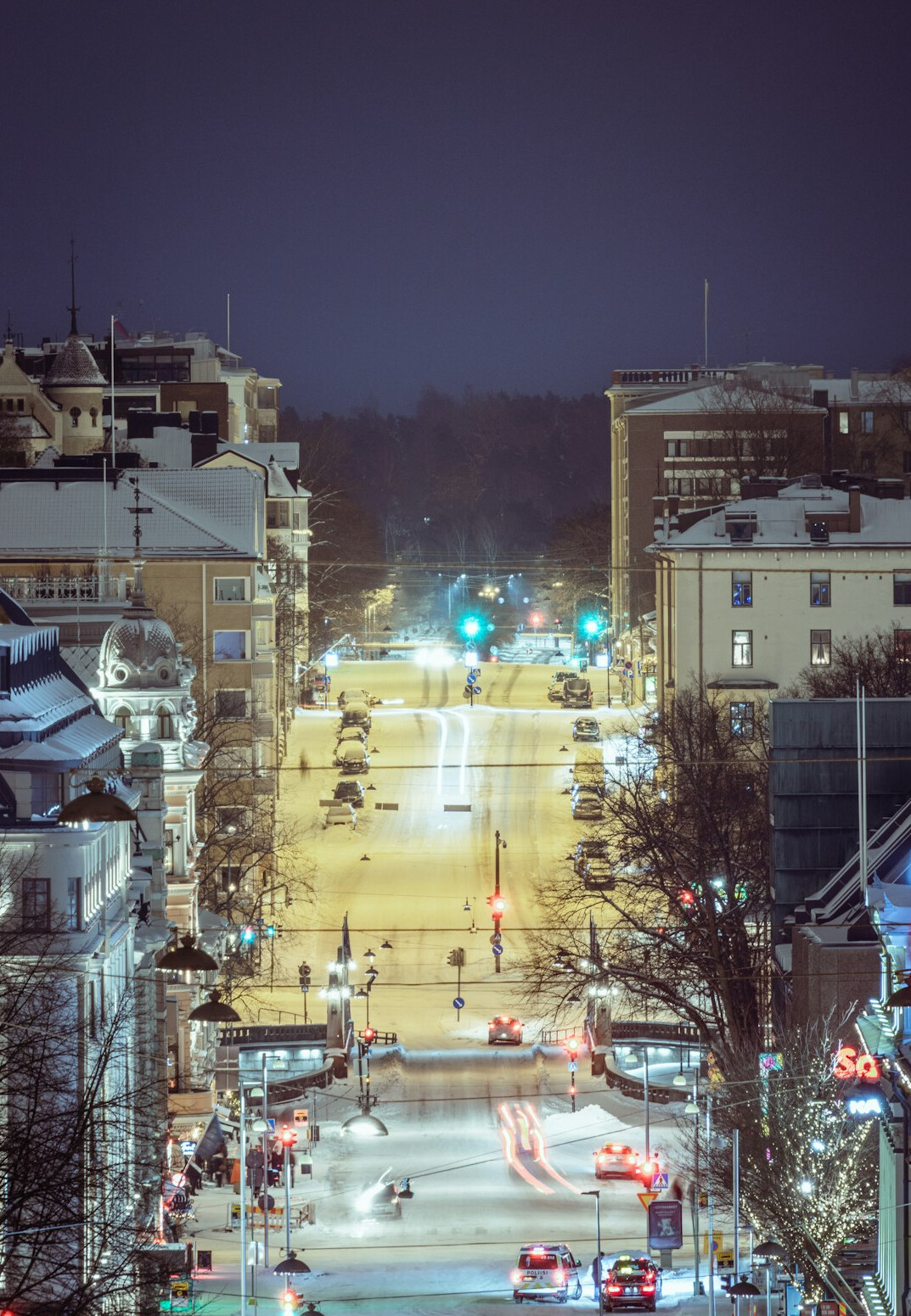 Quiet city street at dusk with distant light