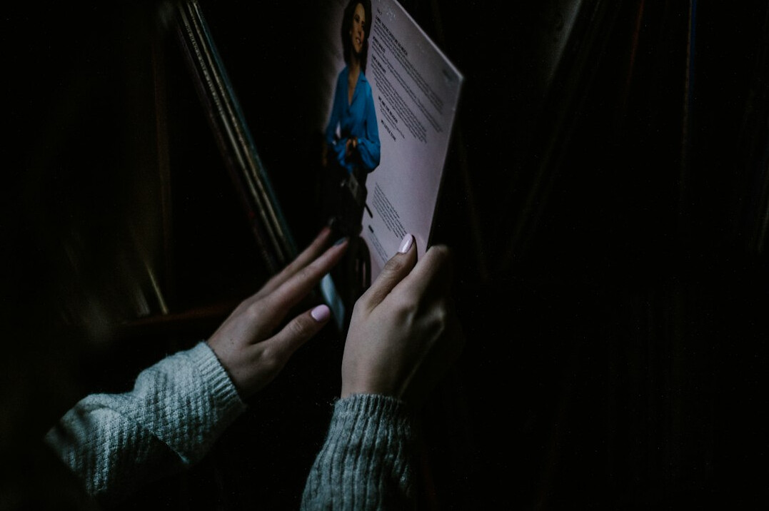 person reading mystery book at night