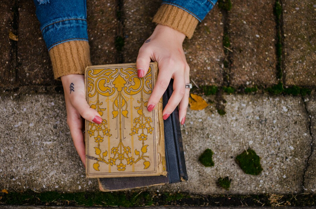 person holding mystery book